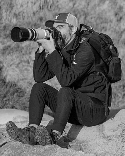 Josh photographing from the rocks with a long lens