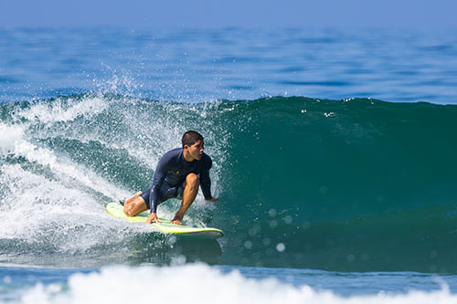 Surfer cutting across a golden wave