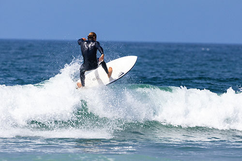 Surfer dropping in on a steep face